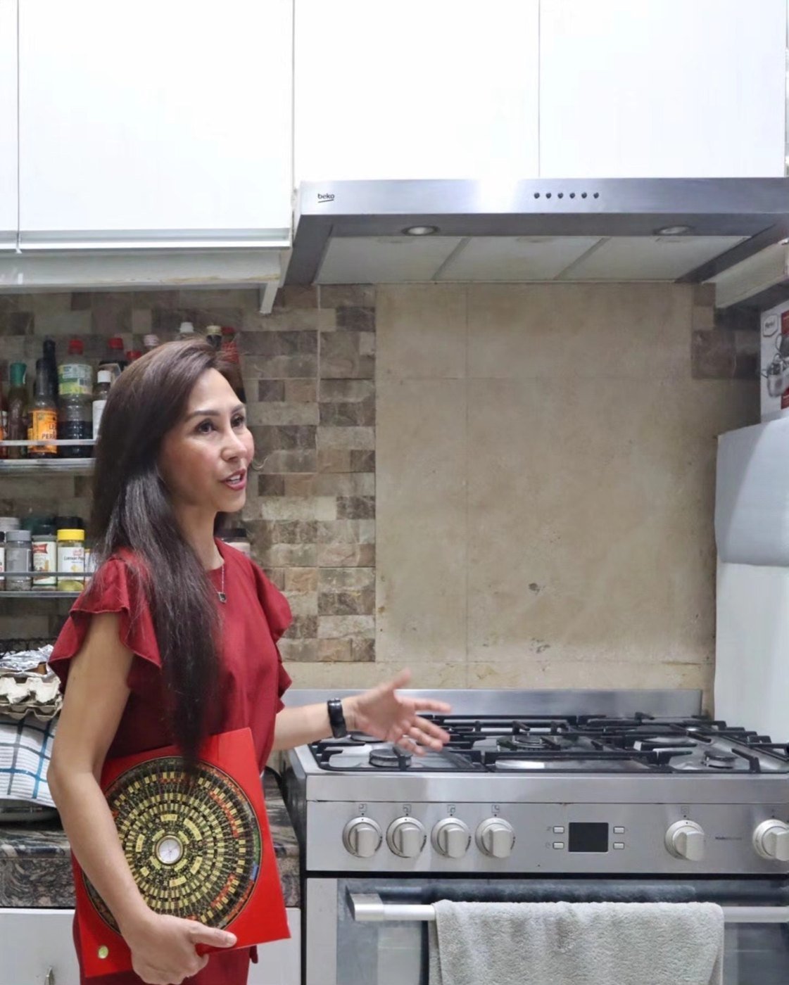 Master Judith holding a Luo Pan during a residential Feng Shui assessment in California, 2025